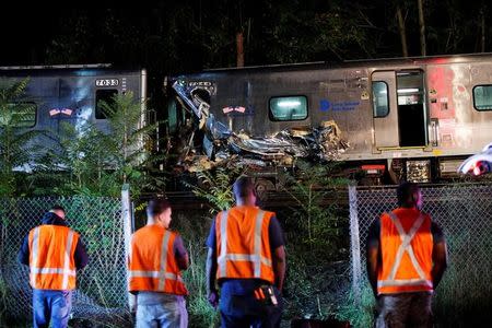 Emergency responders attend to a call of a train derailed near the community of New Hyde Park on Long Island in New York, U.S, October 8, 2016. REUTERS/Eduardo Munoz