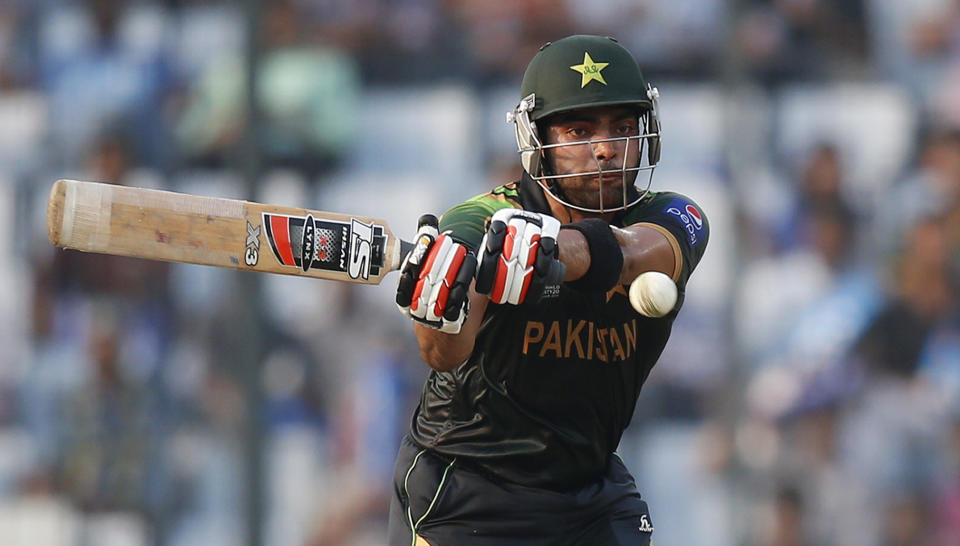 Pakistan's batsman Umar Akmal plays a shot during their ICC Twenty20 Cricket World Cup match against Australia in Dhaka, Bangladesh, Sunday, March 23, 2014. (AP Photo/Aijaz Rahi)