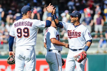 May 20, 2018; Minneapolis, MN, USA; Minnesota Twins first baseman Logan Morrison (99) reacts with shortstop Gregorio Petit (40) after the game against the Milwaukee Brewers at Target Field. Mandatory Credit: Jeffrey Becker-USA TODAY Sports