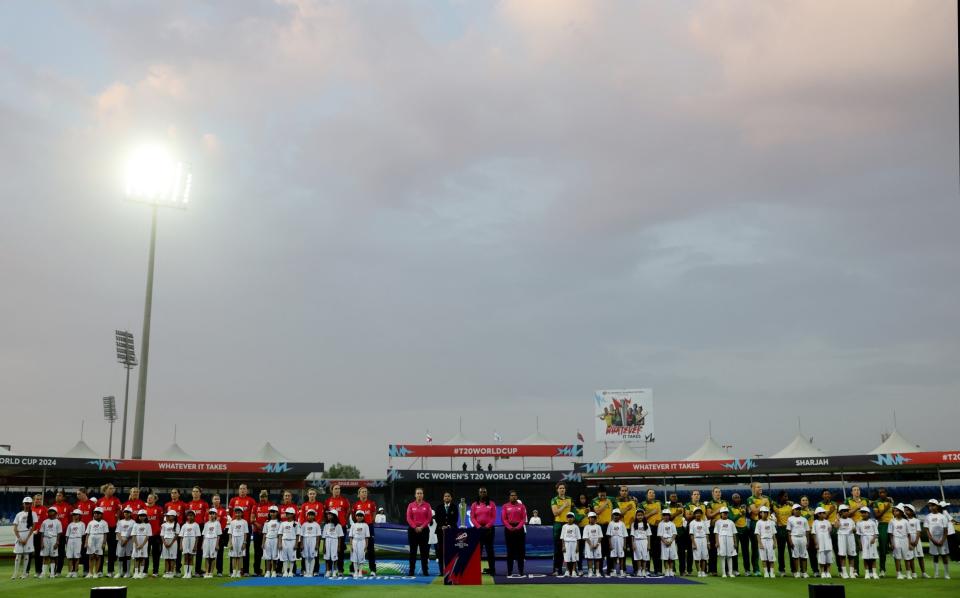 The players line up for the national anthems