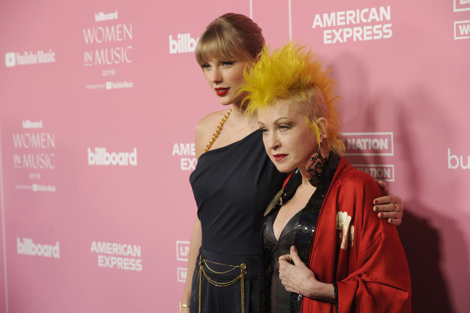 Taylor Swift, left, and Cyndi Lauper arrive at Billboard's Women in Music at the Hollywood Palladium on Thursday, Dec. 12, 2019, in Los Angeles. (AP Photo/Chris Pizzello)