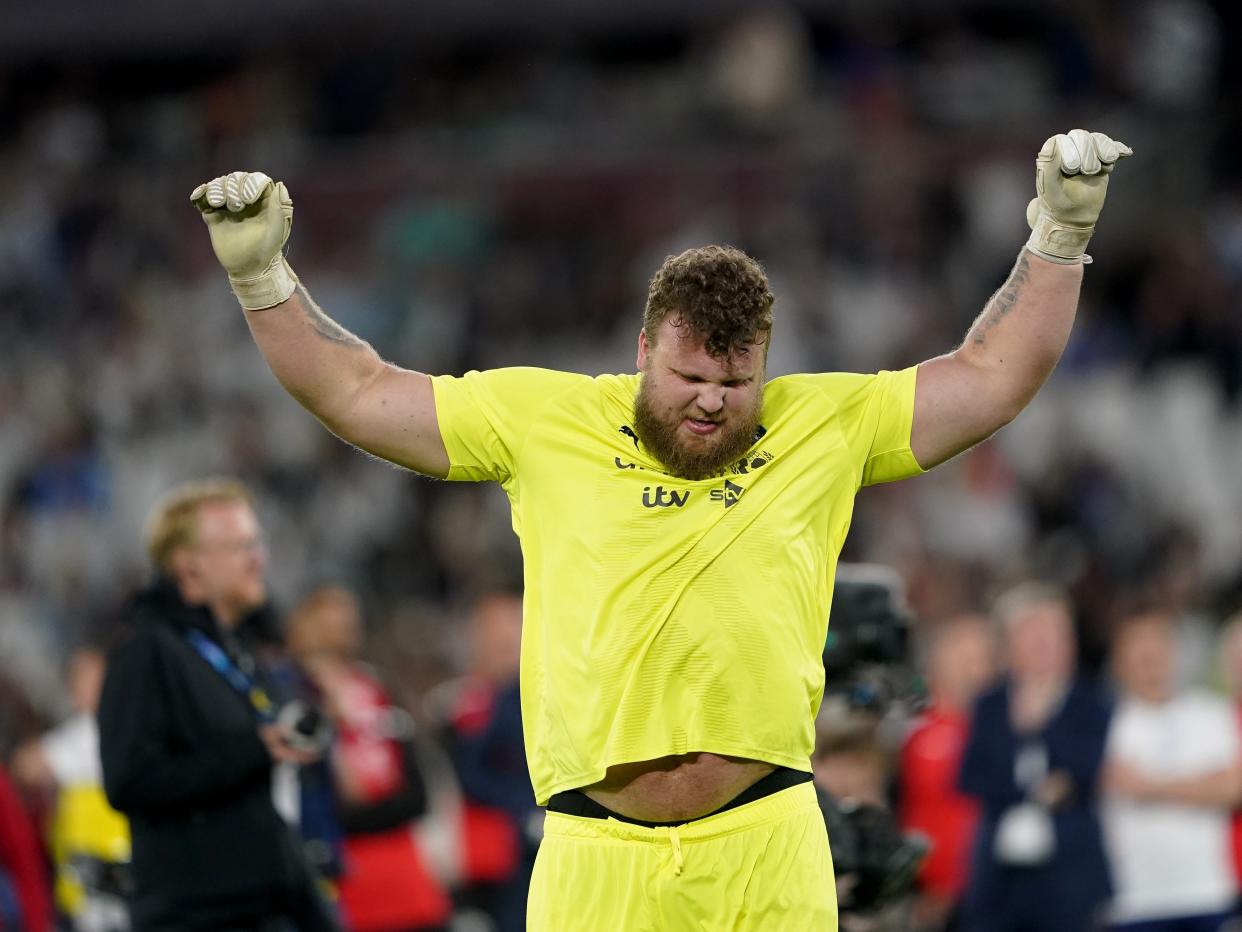 Tom Stoltman at a soccer game with his hands in the air