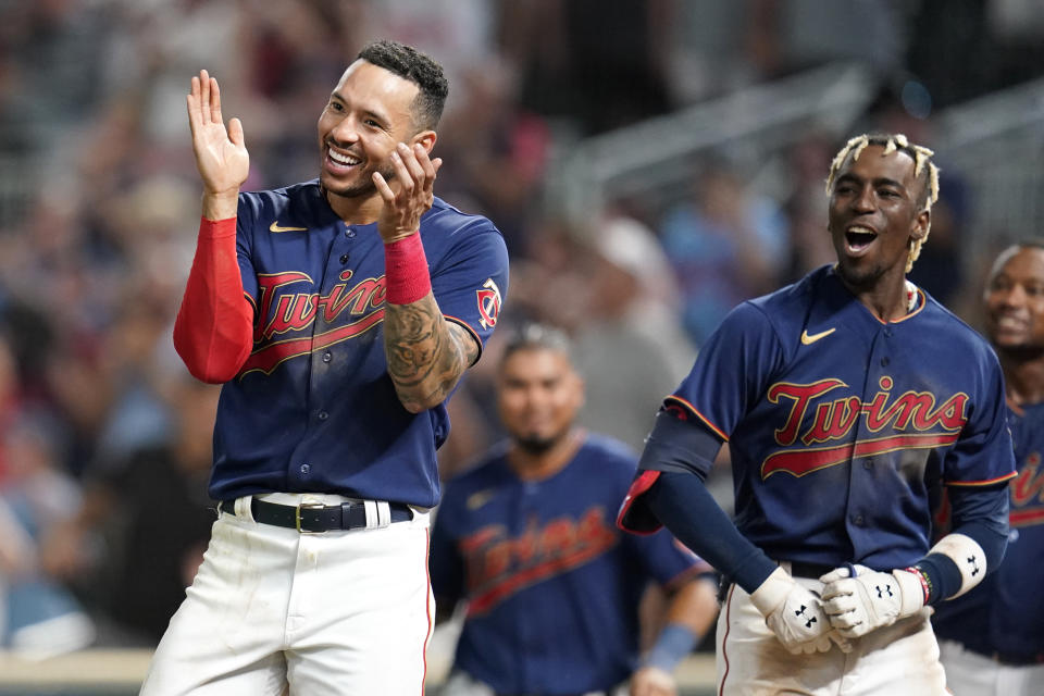 FILE - Minnesota Twins' Carlos Correa, left, and Nick Gordon, front right, celebrate after a walkoff two-run home run by Gio Urshela (not shown) during the bottom of the 10th inning of a baseball game against the Detroit Tigers in Minneapolis, Monday, Aug. 1, 2022. (AP Photo/Abbie Parr)