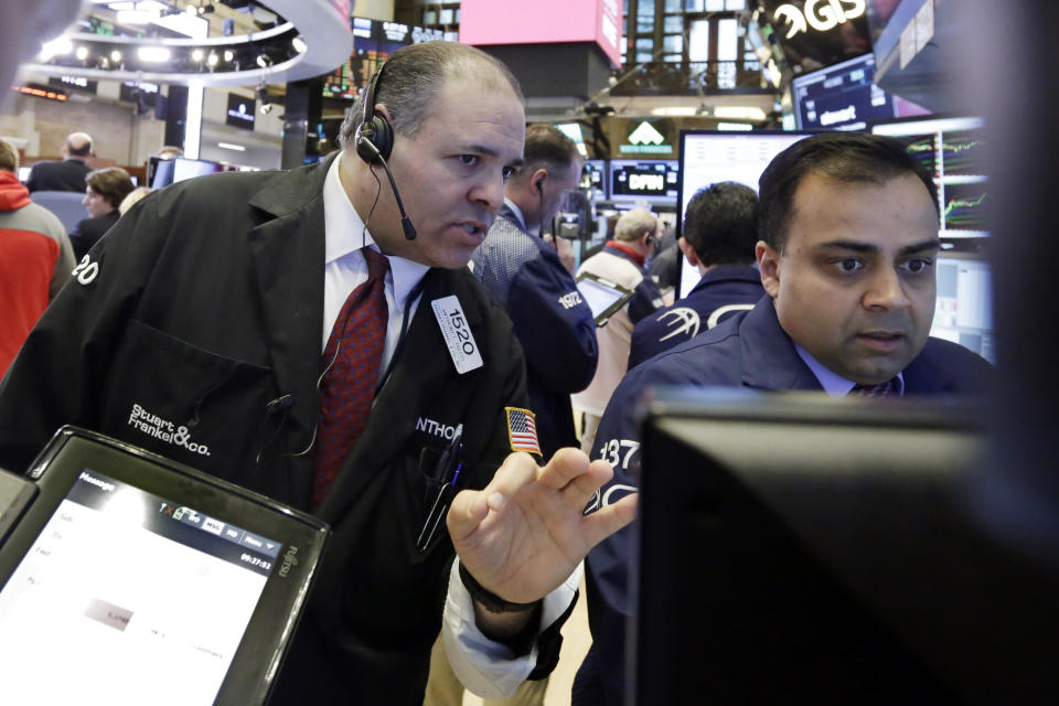 Trader Anthony Riccio, left, and specialist Dilip Patel work on the floor of the New York Stock Exchange, Wednesday, March 29, 2017. Stocks are opening mostly lower on Wall Street led by declines in utilities and real estate companies. (AP Photo/Richard Drew)