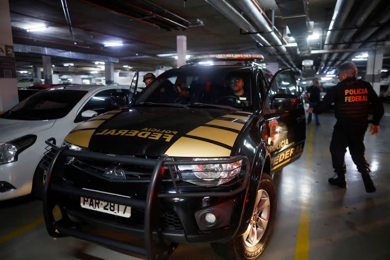 Federal police officers leave the headquarters of the Liberal Party during an operation targeting some of former President Jair Bolsonaro's top aides in Brasilia