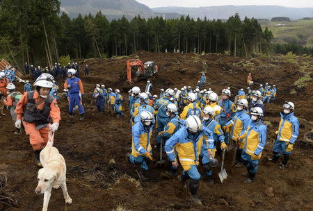 Rescue workers conduct a search and rescue operation at site of houses which collapsed due to a landslide caused by an earthquake in Minamiaso town, Kumamoto prefecture, southern Japan, in this photo taken by Kyodo April 18, 2016. Mandatory credit REUTERS/Kyodo