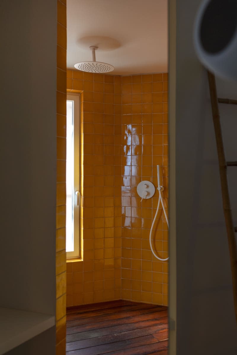 Yellow tiled shower.