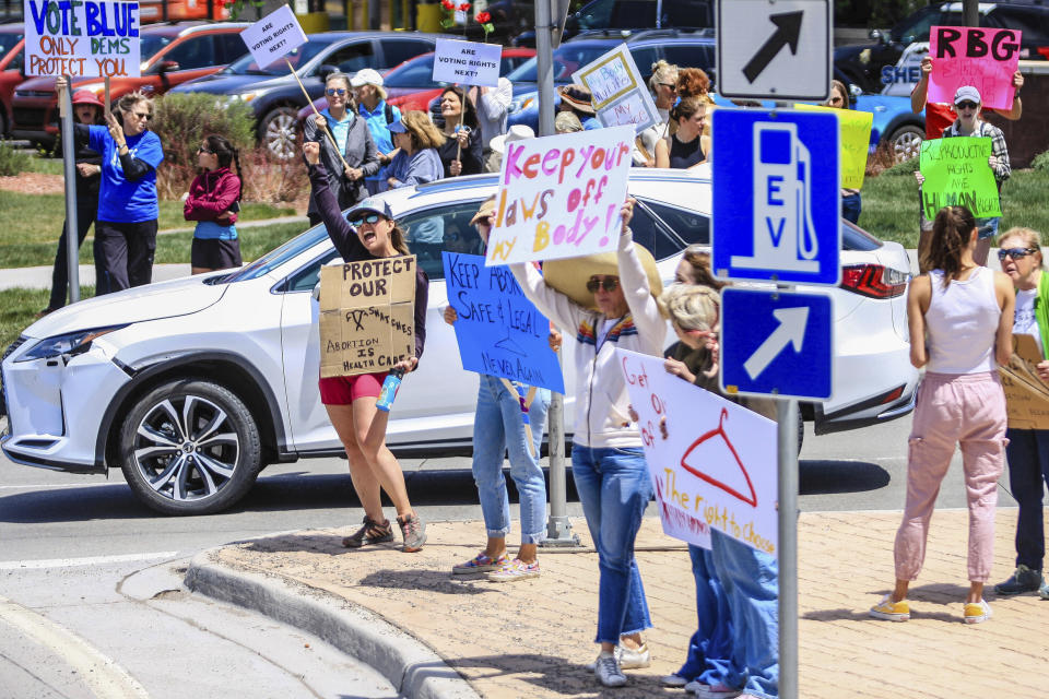 FILE - Abortion rights activists hold signs and protest May 14, 2022 in Edwards, Colo. (Chris Dillmann/Vail Daily via AP, File)