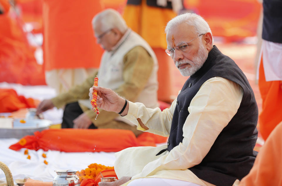 FILE- Indian Prime Minister Narendra Modi, front, performs Hindu rituals sitting at Sangam, the confluence of the Rivers Ganges and Yamuna, at Allahabad, India, Dec. 16, 2018. India is facing major diplomatic outrage from Muslim countries after top officials in the ruling Hindu nationalist party made derogatory references to Islam and the Prophet, drawing accusations of blasphemy across some Arab nations that have left New Delhi struggling to contain the damaging fallout. (AP Photo/Rajesh Kumar Singh, File)