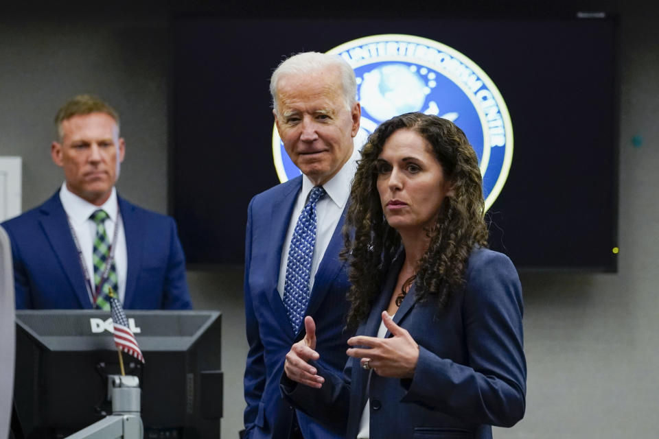 President Joe Biden listens as Director of the National Counterterrorism Center Christine Abizaid speaks during a visit to the Office of the Director of National Intelligence in McLean, Va., Tuesday, July 27, 2021. This is Biden's first visit to an agency of the U.S. intelligence community. (AP Photo/Susan Walsh)