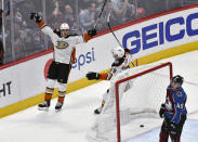 Anaheim Ducks left wing Rickard Rakell (67) celebrates his overtime goal with defenseman Christian Djoos (29), as Colorado Avalanche defenseman Samuel Girard (49) skates by at the end of an NHL hockey game Wednesday, March 4, 2020, in Denver. The Ducks won 3-2. (AP Photo/John Leyba)