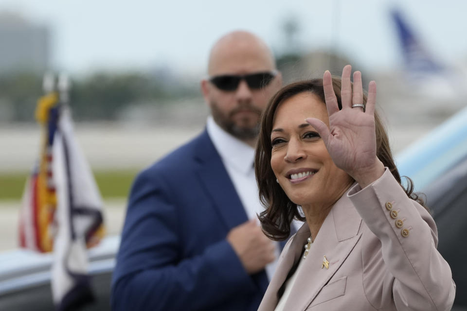 Vice President Kamala Harris waves as she arrives at Miami International Airport, Friday, April 21, 2023, in Miami. Harris traveled to Miami on Friday to announce funding for climate change resiliency projects across the U.S. (AP Photo/Rebecca Blackwell)