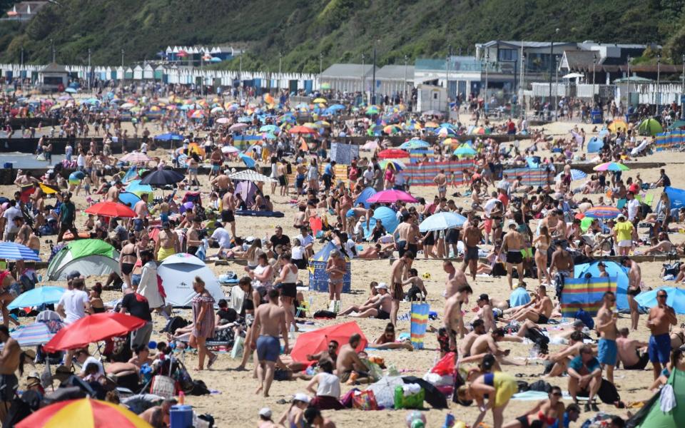 People enjoy the hot weather at Bournemouth beach during the UK's spring bank holiday  - Finnbarr Webster/Getty Images Europe