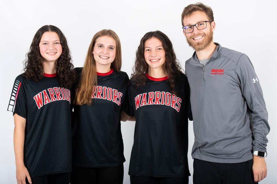 (From left) Susquehannock basketball players Elena Snyder, Annie Laubach and Georgie Snyder pose for a photo with head coach Alex Fancher during YAIAA winter sports media days Thursday, November 9, 2023, in York.