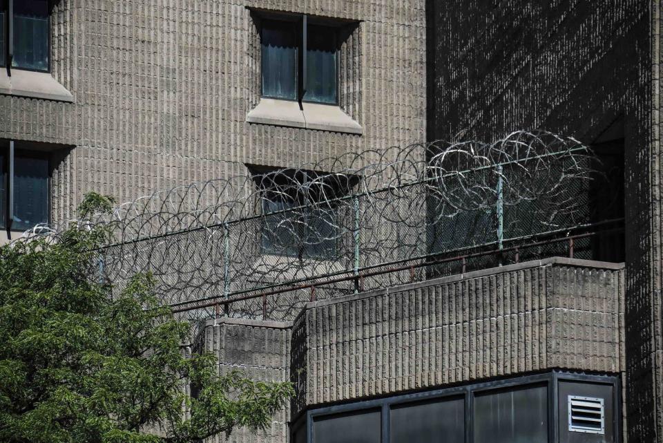 FILE - This Aug. 10, 2019, shows razor wire fencing at the Metropolitan Correctional Center in New York. Once hailed as a prototype for a new kind of federal jail and the most secure in the country, the Metropolitan Correctional Center has become a blighted wreck, with infrastructure so crumbling it’s impossible to safely house inmates there. And so the Justice Department said last month it would close the jail by the end of October to undertake much-needed repairs. But it may never reopen. (AP Photo/Bebeto Matthews, File)