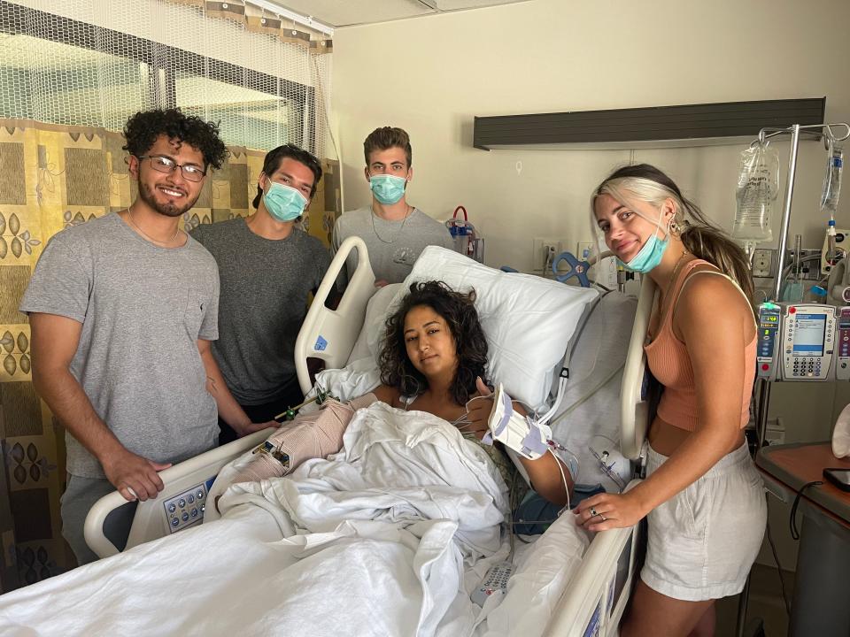 Taj Bldiar's friends, including best friend Megan Rector, visit her in the hospital. Bldiar's right arm was nearly severed in a boating accident near Crab Island.