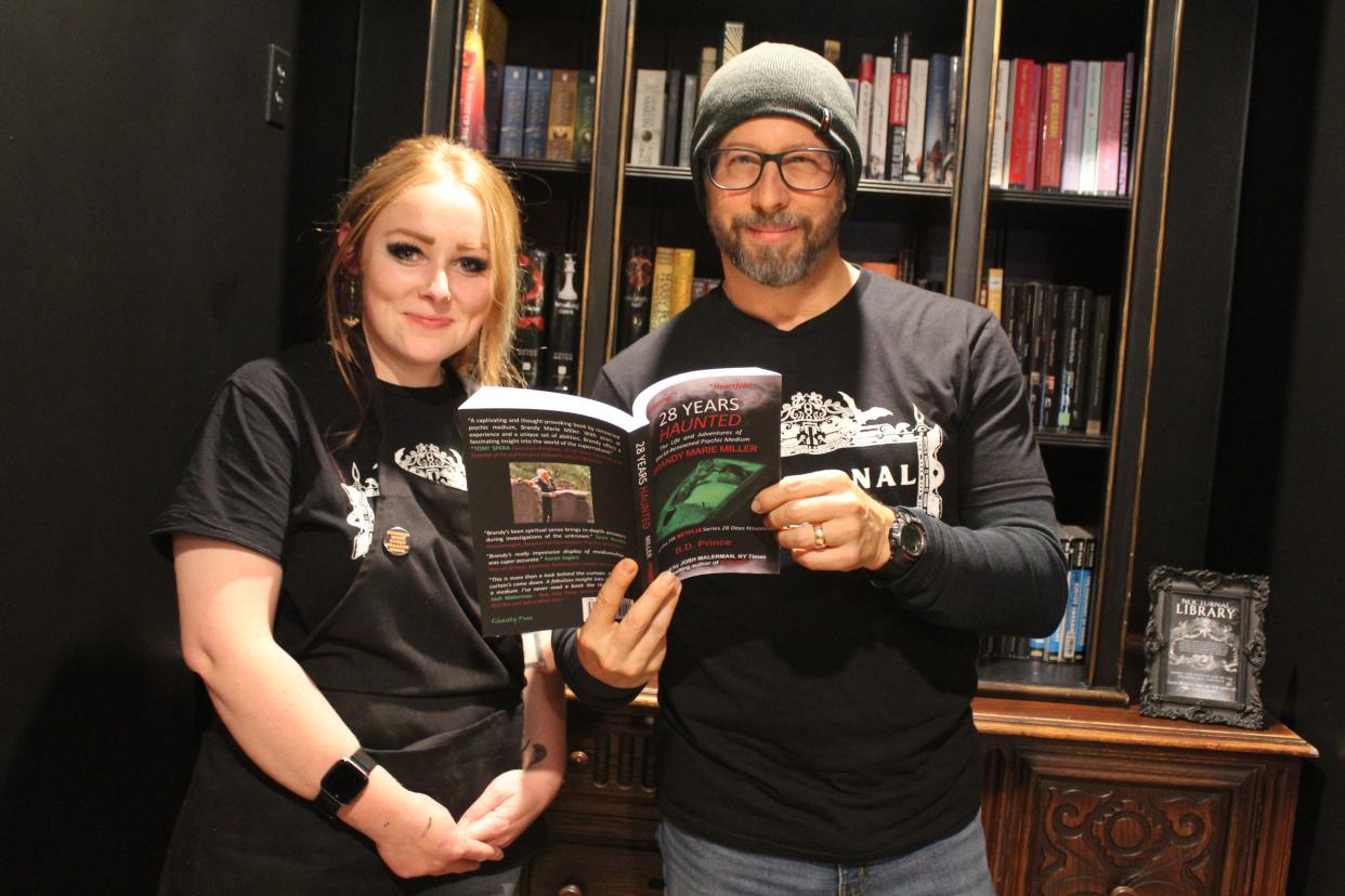 Owner of Nocturnal Hannah Holdwick, left, stands with author Bryan Prince. The former Flat Rock author donated his latest book, “28 Years Haunted The Life and Adventures of World-Renowned Psychic Medium Brandy Marie Miller,” to the shop's lending library.