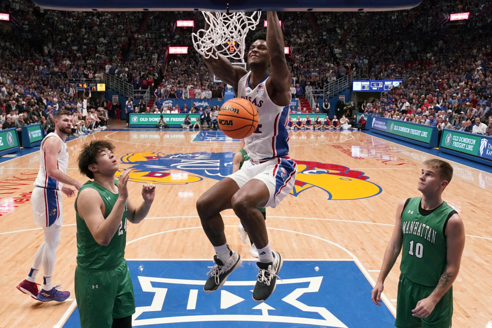 Kansas forward K.J. Adams Jr. dunks the ball during the first half of an NCAA college basketball game against Manhattan Friday, Nov. 10, 2023, in Lawrence, Kan. (AP Photo/Charlie Riedel)