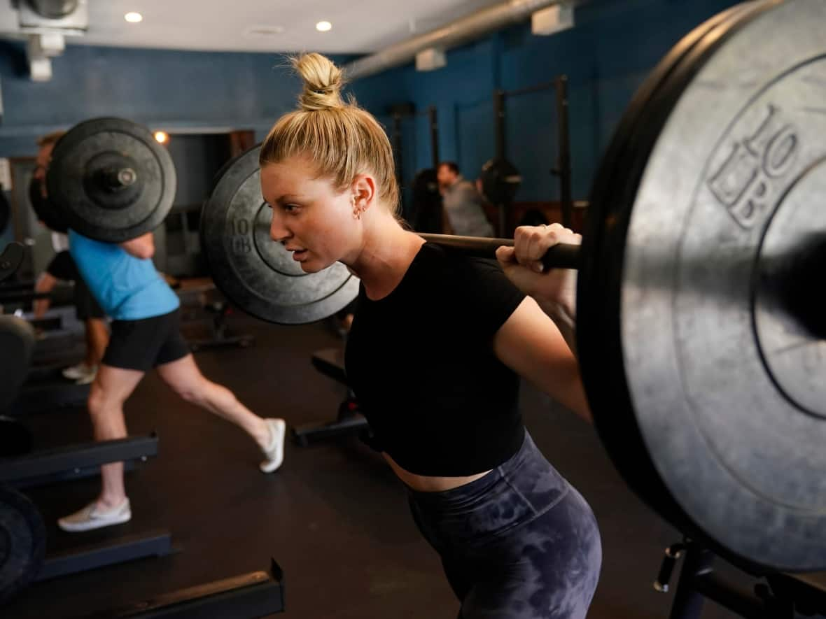 Instead of New Year's resolutions, many have turned to wellness-related social media challenges to overhaul their lifestyles, such as 75 Hard. It requires two workouts a day, sticking to a diet and no alcohol —for 75 days straight.  (Marcio Jose Sanchez/AP - image credit)