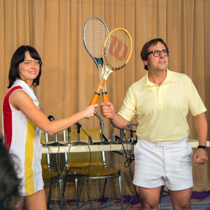 Billie Jean king and Bobby Riggs posing with their tennis rackets touching in Battle of the Sexes