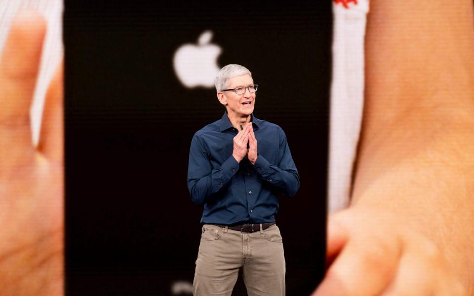 Tim Cook unveiling the new iPhones last week - AFP