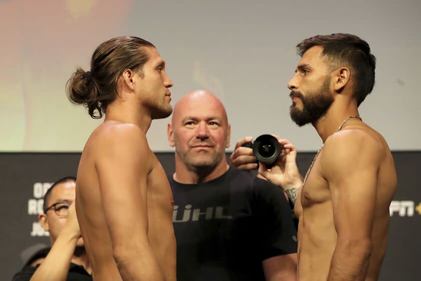 Yair Rodriguez, right, and Brian Ortega face off during a ceremonial weigh-in for the UFC on ABC 3 mixed martial arts event, Friday, July 15, 2022, in Elmont, NY. (AP Photo/Gregory Payan)