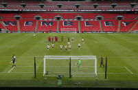 Arsenal's Pierre-Emerick Aubameyang celebrates with Arsenal goalkeeper Emiliano Martinez, front left, after scores the winning penalty in a penalty shootout at the end of the English FA Community Shield soccer match between Arsenal and Liverpool at Wembley stadium in London, Saturday, Aug. 29, 2020. (Andrew Couldridge/Pool via AP)