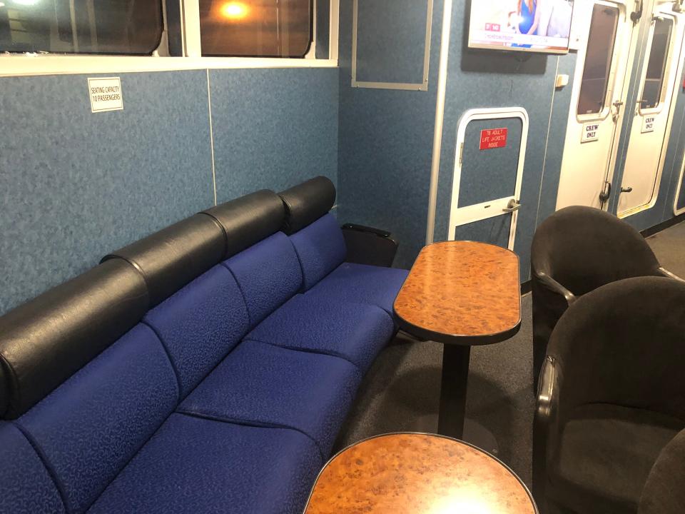 Curved couch around tiny tables on Key West Ferry