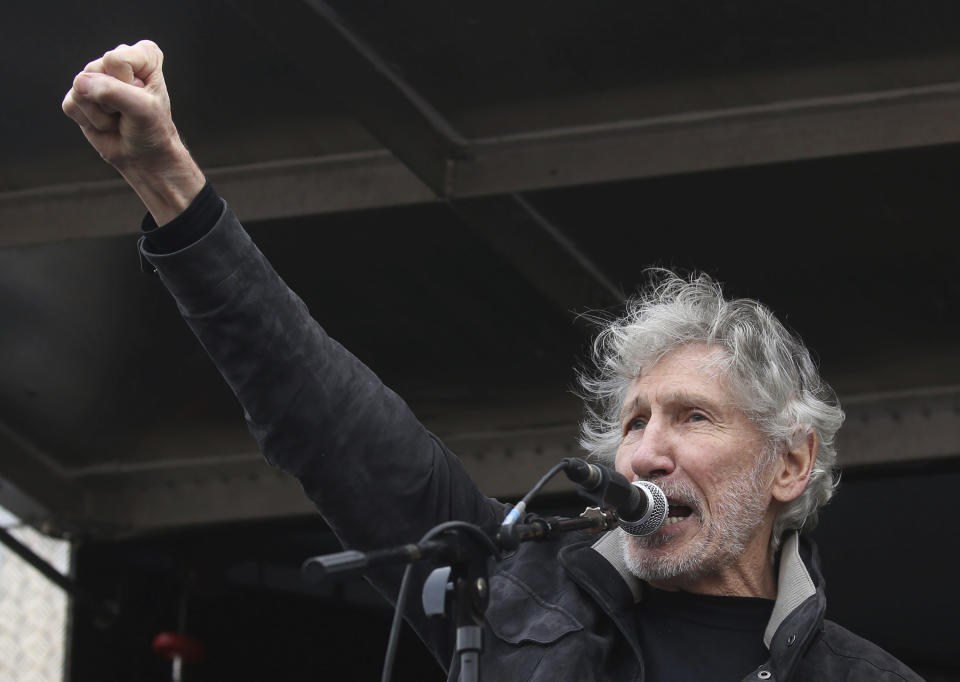 Former Pink Floyd bass player Roger Waters speaks to crowds gathered at Parliament Square in London, protesting against the imprisonment and extradition of Wikileaks founder Julian Assange extradition, Saturday Feb. 22, 2020. (Isabel Infantes/PA via AP)