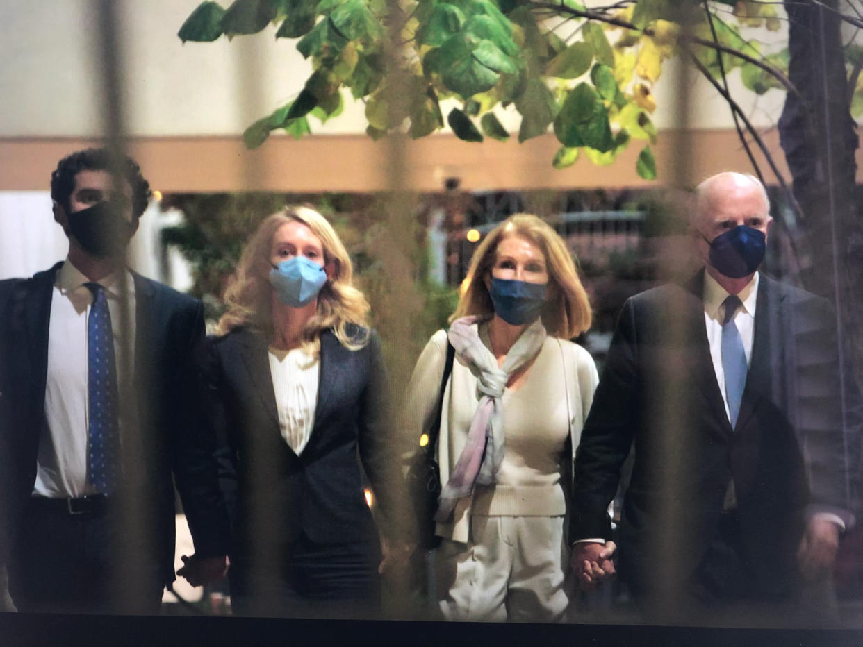 Elizabeth Holmes leaves court with family members on Friday, Dec. 17, 2021. (Credit: Yahoo Finance)