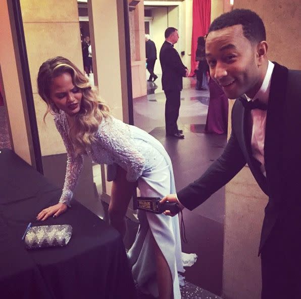 Legend scans Teigen at the security checkpoint at the 2015 Oscars in an Instagram the model captioned, 