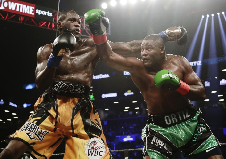 Deontay Wilder, left, and Luis Ortiz trade punches during the third round of the WBC heavyweight championship bout Saturday, March 3, 2018, in New York. Wilder stopped Ortiz in the 10th round. (AP Photo/Frank Franklin II)