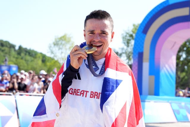 Great Britain’s Tom Pidcock poses with his gold medal