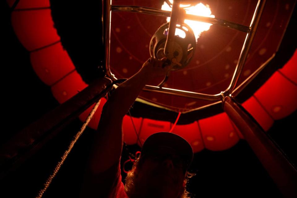 A hot air balloon pilot fires the burners inside his balloon during the Gulf Coast Hot Air Balloon Festival at OWA in Foley, Alabama on Thursday, May 4, 2023.