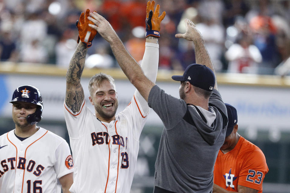 Houston Astros pinch hitter J.J. Matijevic, second from left, celebrates with Justin Verlander after hitting a walkoff single during the ninth inning in the first game of a baseball doubleheader against the New York Yankees, Thursday, July 21, 2022, in Houston. (AP Photo/Kevin M. Cox)