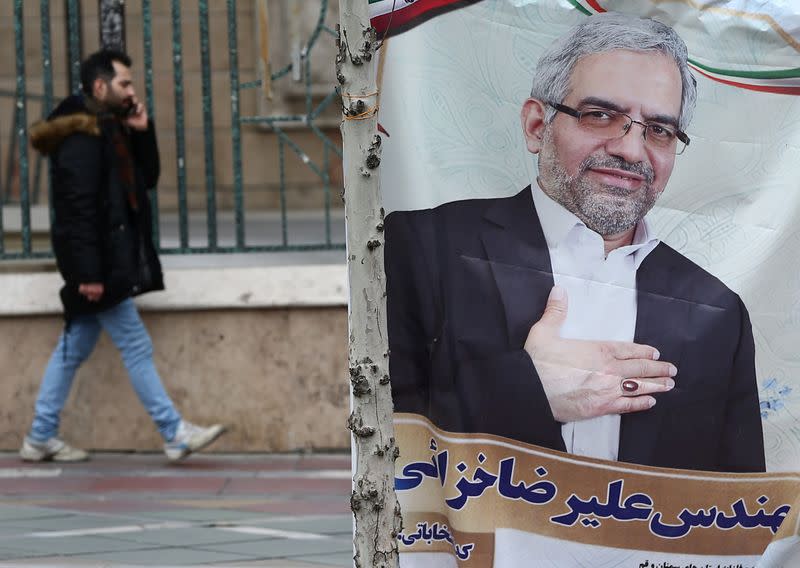A banner of a parliamentary candidate is seen in Tehran