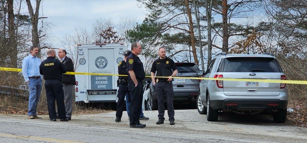 Authorities gather Tuesday at a taped-off area along Middlebury Road near its intersection with the Summit Metro Parks Freedom Trail.