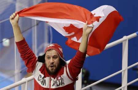 Ice Hockey – Pyeongchang 2018 Winter Olympics – Women Preliminary Round Match - U.S. v Canada - Kwandong Hockey Centre, Gangneung, South Korea – February 15, 2018 - A Canadian fan waves the Canadian national flag during a game with Team USA. REUTERS/David W Cerny