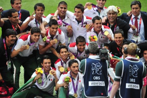 Los jugadores de la selección mexicana de fútbol celebran su medalla de oro en los JJOO, este sábado en Londres. Este partido servirá para que la afición mexicana rinda un homenaje al equipo de futbol sub-23 que ganó la medalla oro en el torneo olímpico de Londres-2012. (AFP | glyn kirk)