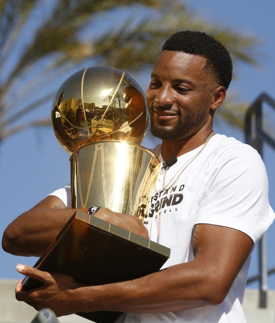 San Diego native Norman Powell clutches the Larry O'Brien Trophy before meeting fans at Lincoln High, his alma mater.