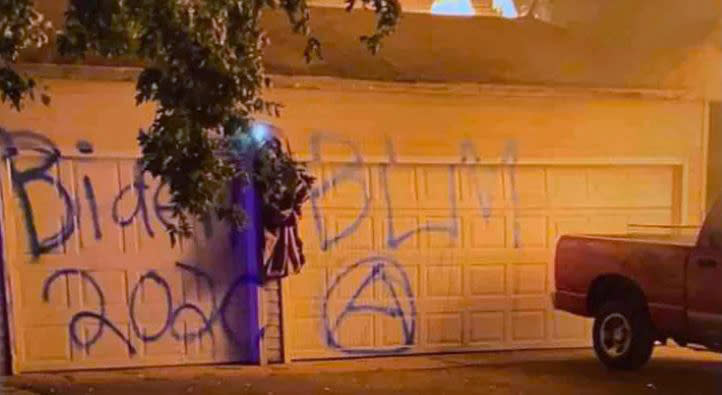 Police say Denis Molla spray painted his own garage door with with graffiti. (via GoFundMe)