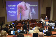 Professor Randall Johnson of the Nobel Commitee, right, speaks during a news conference in Stockholm, Sweden, Monday Oct. 7, 2019. The 2019 Nobel laureates in Physiology or Medicine has been awarded to scientists Gregg L. Semenza, Peter J. Ratcliffe and William G. Kaelin Jr. receiving the award jointly for their discoveries of "how cells sense and adapt to oxygen availability". (Pontus Lundahl/TT via AP)