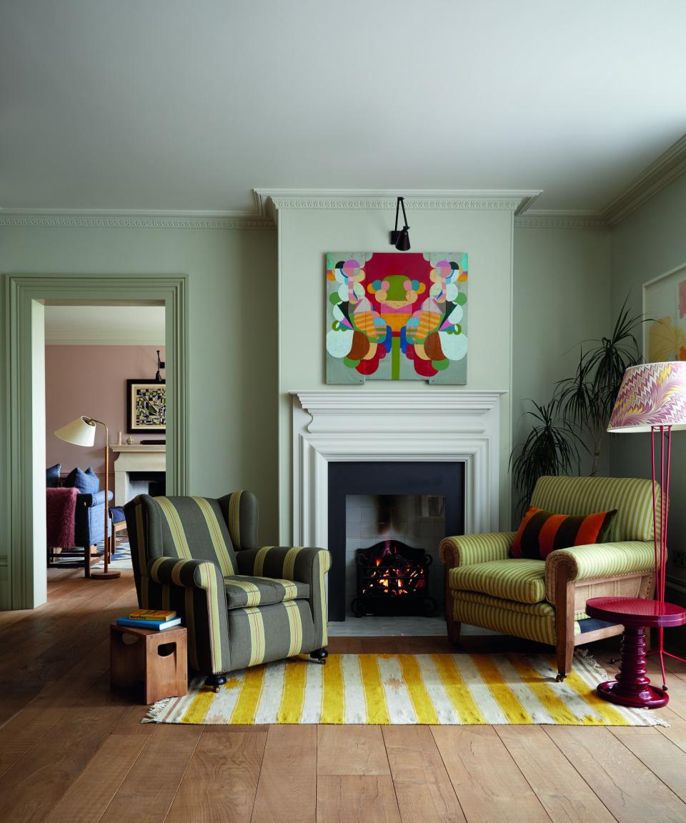 Living room with gray-green walls and statement artwork