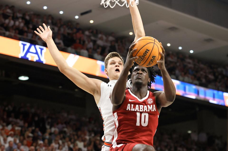 Feb 1, 2022; Auburn, Alabama, USA; Alabama Crimson Tide center Charles Bediako (10) shoots and is fouled bye Auburn Tigers forward Walker Kessler (13) during the first half at Auburn Arena. Mandatory Credit: John Reed-USA TODAY Sports