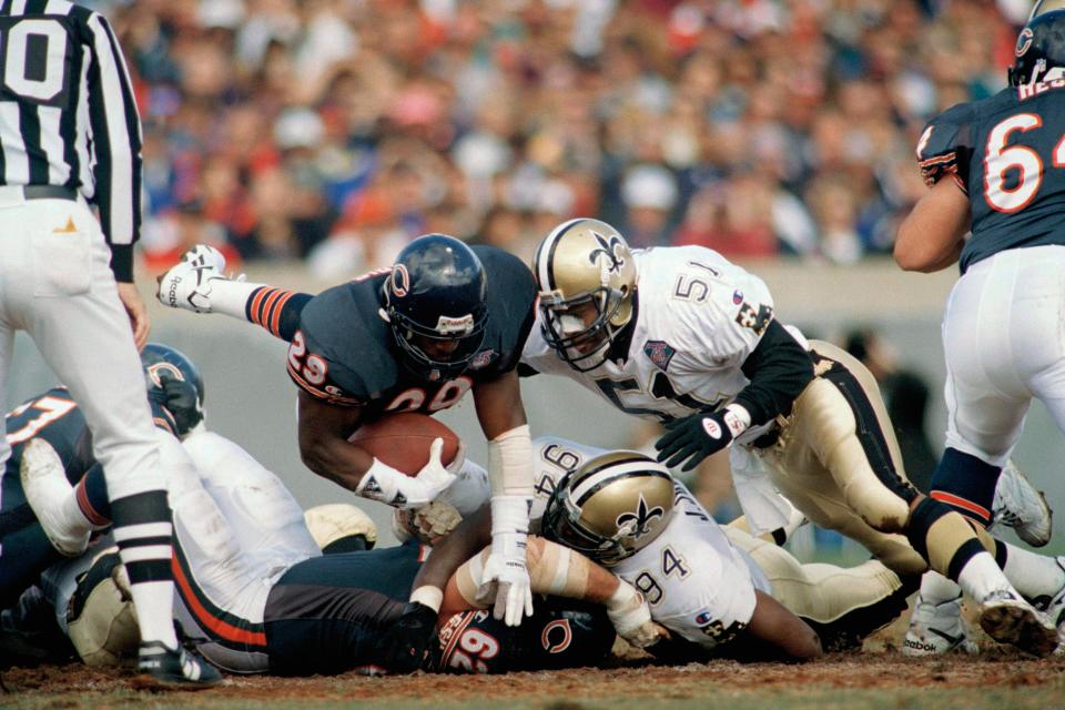 Saints linebacker Sam Mills (51) comes in for the hit on the Chicago Bears running back Raymont Harris (29) during the first quarter, Oct. 9, 1994, at Soldier Field in Chicago.