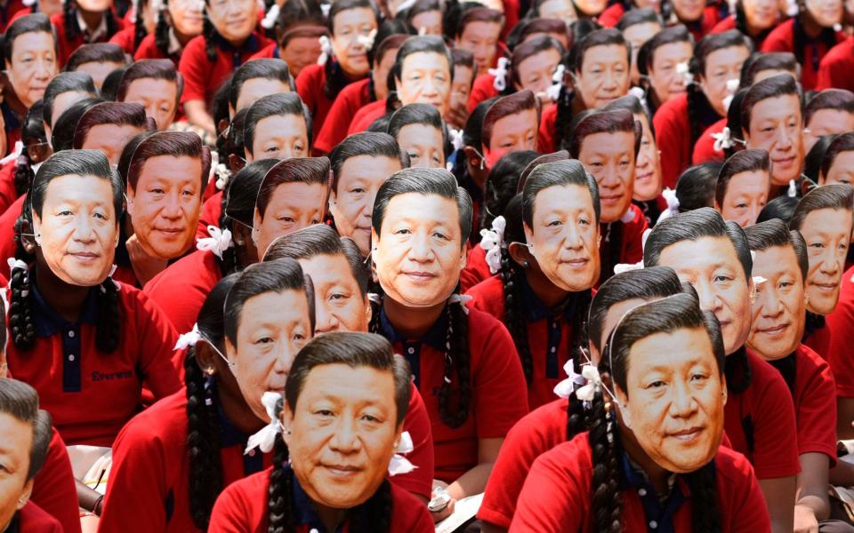 Indian school students wear masks of President Xi Jinping ahead of a summit between China and India in 2019 - ARUN SANKAR /AFP