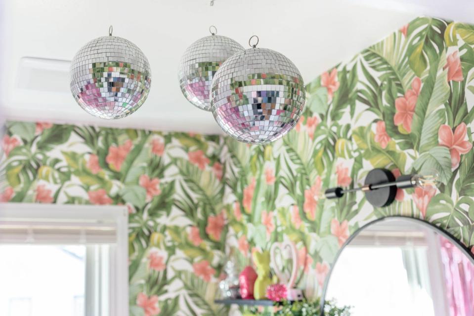 Disco balls hang from the ceiling in the bathroom at this home in Louisville's Fern Creek area, which was inspired by Miami.