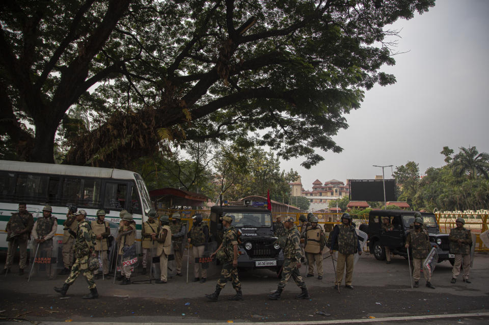 Indian policemen guard near Assam state legislature building during a curfew in Gauhati, India, Thursday, Dec. 12, 2019. Police arrested dozens of people and enforced curfew on Thursday in several districts in India’s northeastern Assam state where thousands protested legislation granting citizenship to non-Muslims who migrated from neighboring countries. (AP Photo/Anupam Nath)