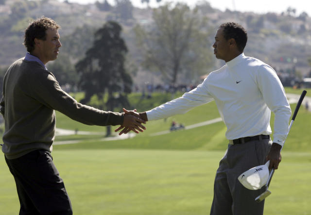 FILE - Tiger Woods, right, shakes hands with Stephen Ames after Woods' 9 and 8 victory in the first round of the World Match Play Golf Championship, Wednesday Feb. 22, 2006, in Carlsbad, Calif. That remains the Match Play record for largest margin of victory. (AP Photo/Chris Carlson, File)