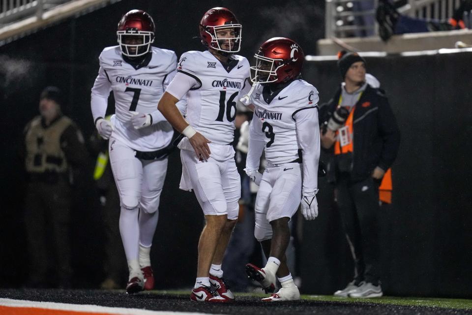 Cincinnati Bearcats quarterback Brady Lichtenberg (16) and Cincinnati Bearcats wide receiver Aaron Turner (9) celebrate a touchdown pass in the fourth quarter of the NCAA Big12 football game between the Oklahoma State Cowboys and the Cincinnati Bearcats at Boone Pickens Stadium in Stillwater, Okla., on Saturday, Oct. 28, 2023.